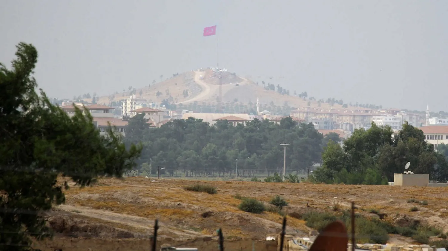 A Turkish flag flies across the border from Ras al Ain, Syria, Oct. 19, 2019. (Reuters)