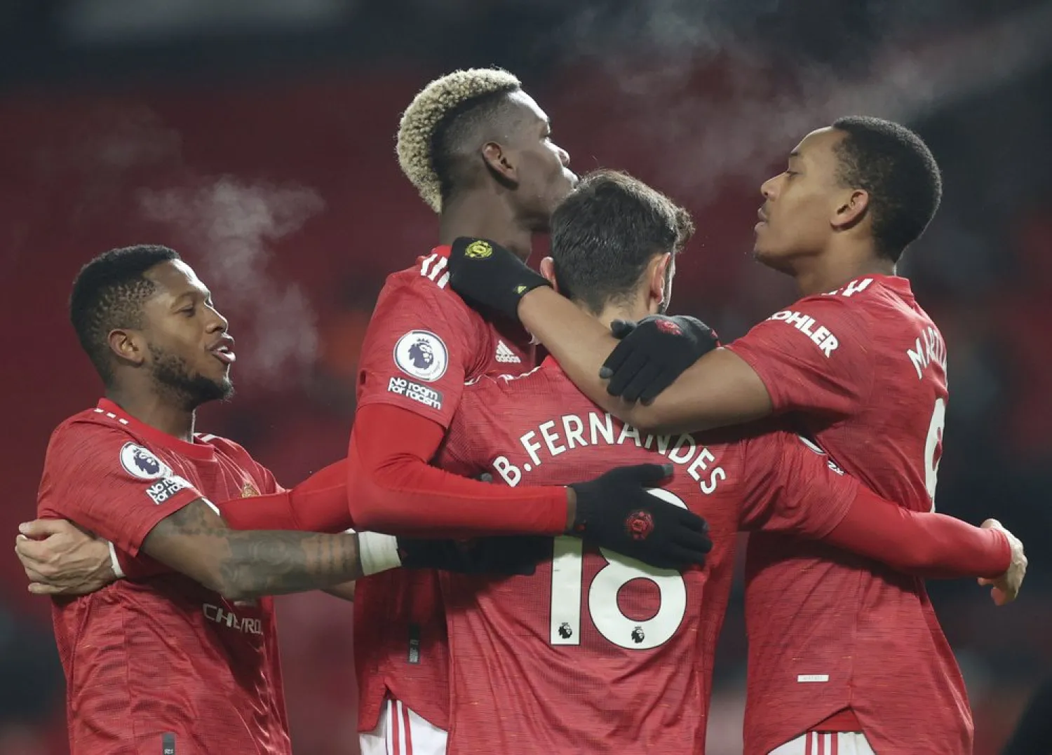 Manchester United's Bruno Fernandes, (18), celebrates with teammates after scoring his side’s second goal against Aston Villa at Old Trafford in Manchester, England, Jan. 1, 2021. (AP)