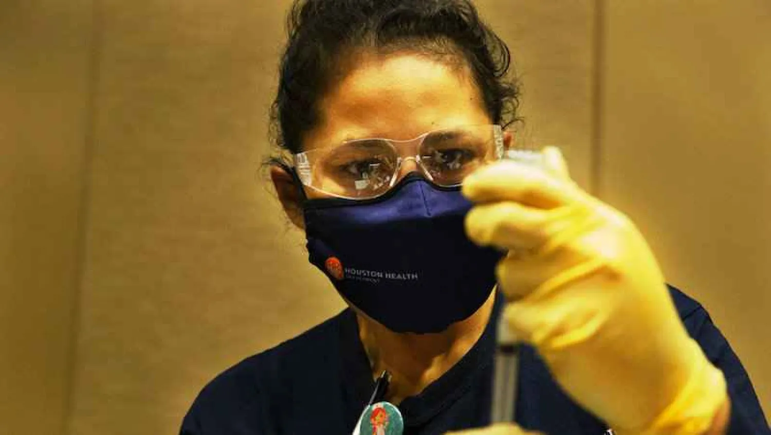 Houston Health Department LVN Alicia Meza prepares a dose of COVID-19 vaccine Sunday, Jan. 3, 2021, at a Houston Health Department's COVID-19 vaccine clinic in Houston. The department vaccinated 1,008 people who qualify under Phase 1A or Phase 1B of the state's guidelines at the clinic's first day on Saturday. (Yi-Chin Lee/Houston Chronicle via AP)