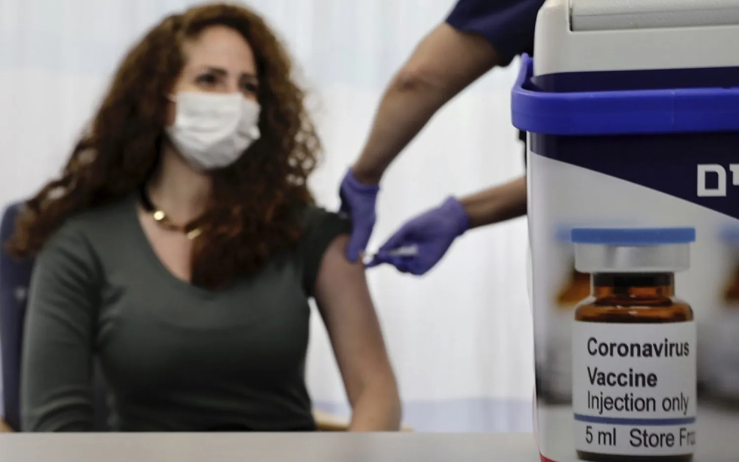 An Israeli nurse shows the media a simulated vaccination as part of the hospital's preparation for the coronavirus vaccinations, at the Sheba Tel Hashomer Hospital in Ramat Gan, December 10, 2020. (AP) 