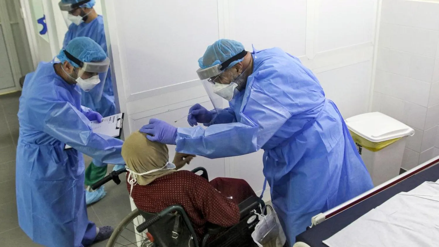 A doctor tests a woman at a hospital in the southern Lebanese city of Nabatieh on April 4, 2020. AFP file photo