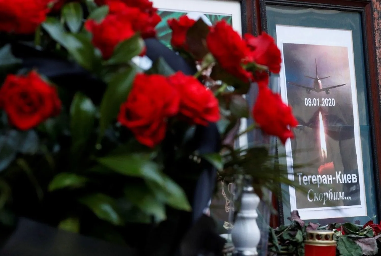 Flowers and a memorial poster are placed outside the Iranian Embassy to commemorate the victims of the Ukraine International Airlines plane crash, in Kiev, Ukraine January 8, 2020. (Reuters)