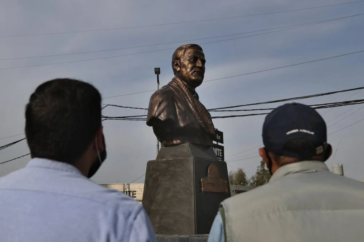 Hezbollah supporters look at a statue of Qassem Soleimani installed to commemorate the anniversary of his killing, in a US drone strike in Baghdad, in Ghobeiry, a suburb of Beirut, Lebanon, Jan. 6, 2021. (AP)