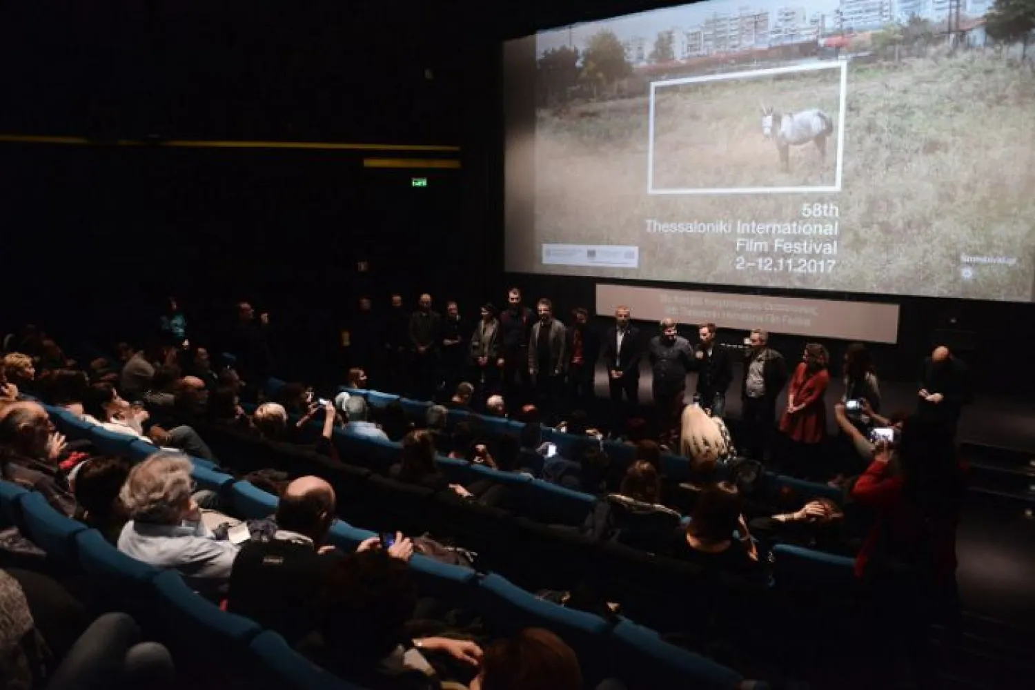 Macedonian film director Gjorce Stavreski (5th R) stands on stage during the presentation of the cast of his film "Secret Ingredient" at the Thessaloniki film festival in 2017. Reuters