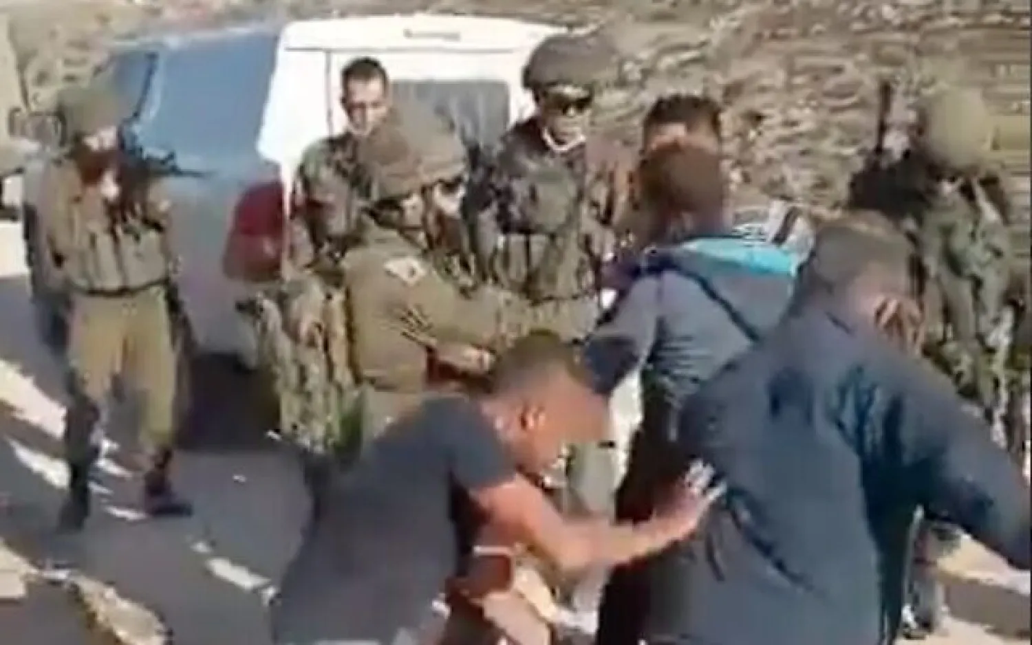 Palestinians scuffle with Israeli soldiers outside of al-Tuwani in the West Bank, on January 1, 2021 (screenshot)