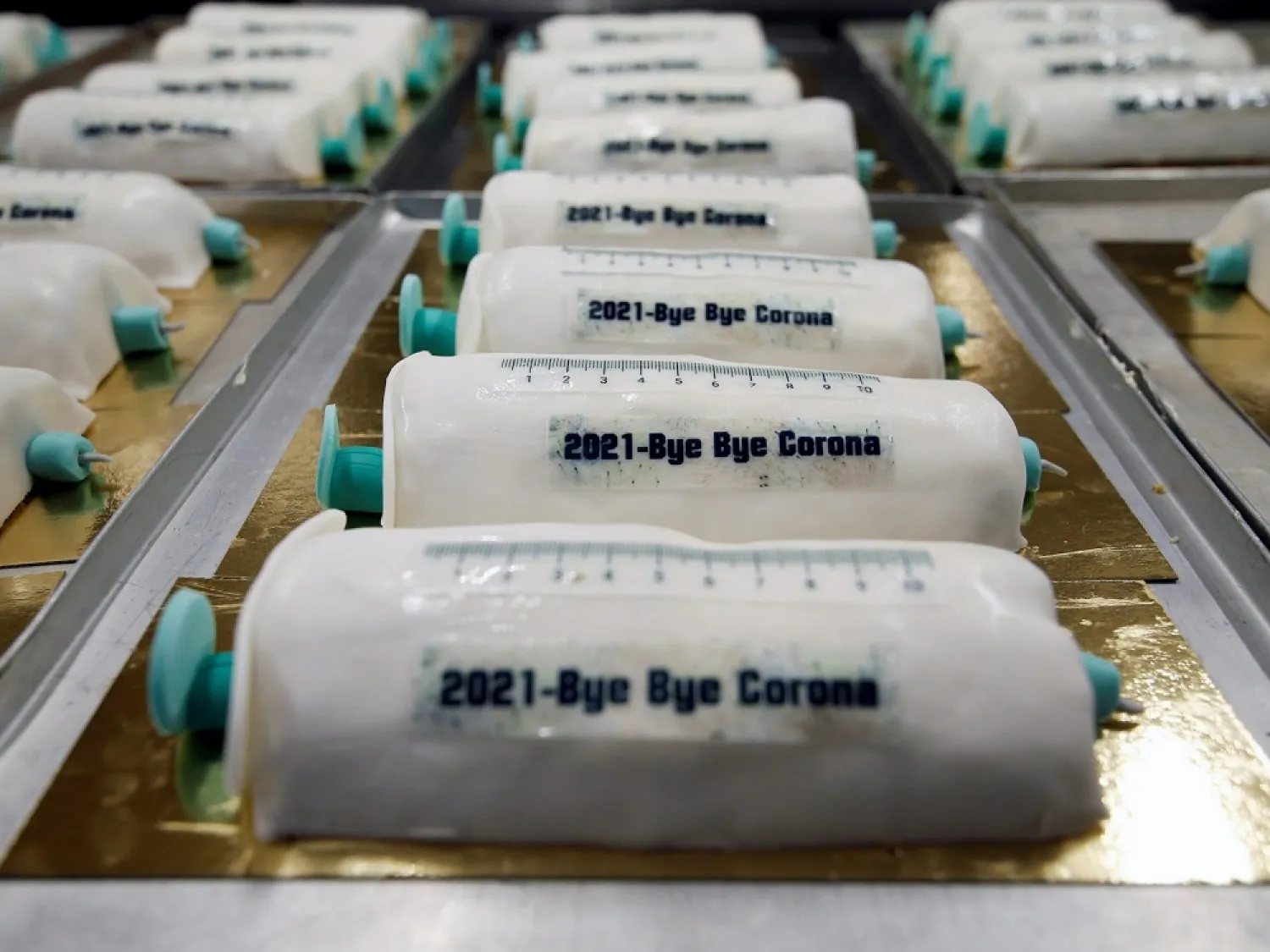 Cakes in the shape of syringes are seen at the Schuerener Backparadies bakery, as the vaccination rollout against COVID-19 continues, in Dortmund, Germany, Jan. 8, 2021. (Reuters)