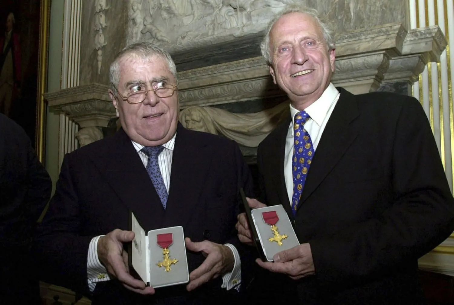 In this Oct. 31, 2002 file photo, Albert, left and Michel Roux display their honorary OBE medals presented to them by the British Foreign Secretary Jack Straw, on behalf of Britain's Queen Elizabeth. (AP)