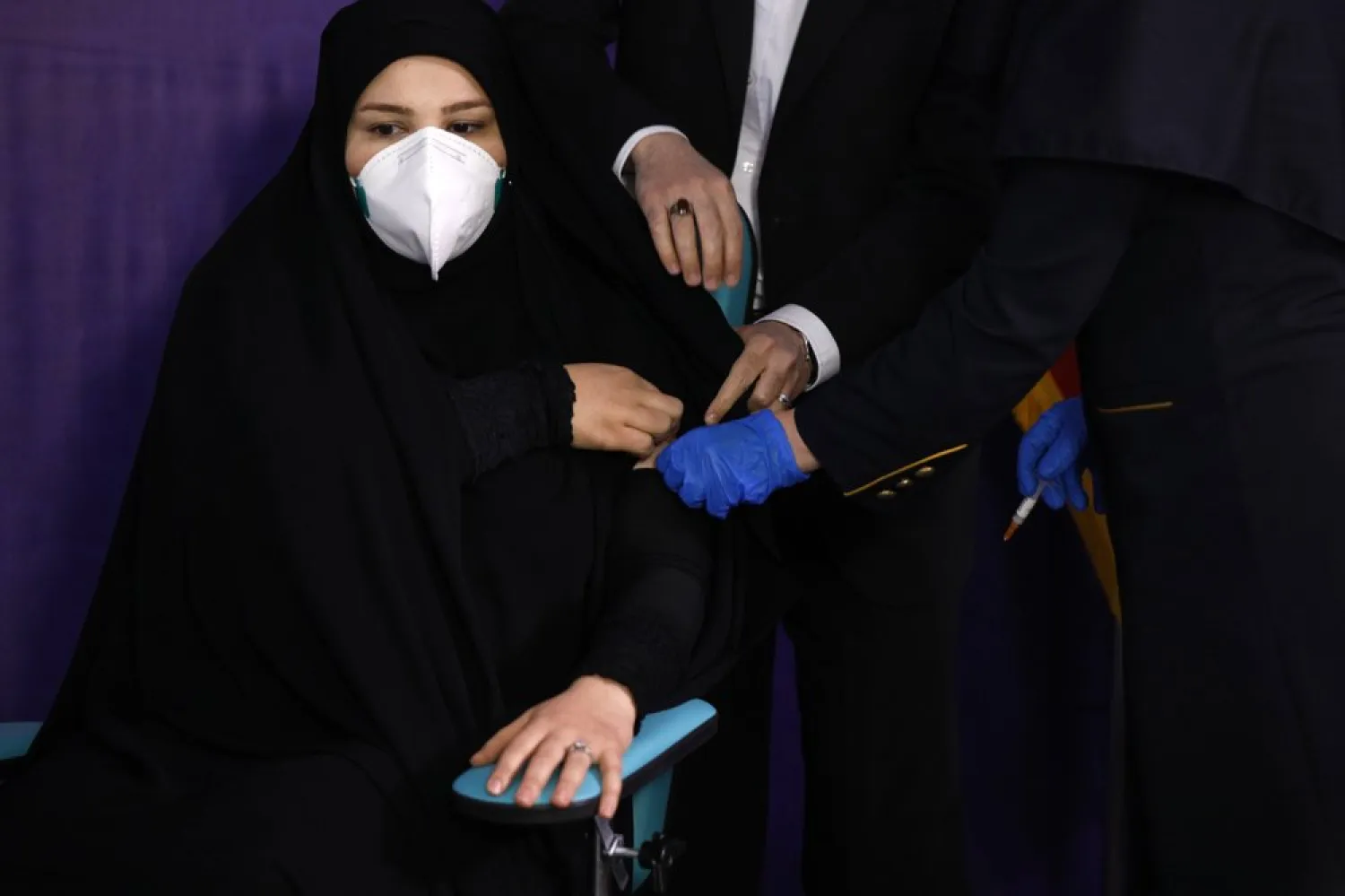 Tayebeh Mokhber is injected with the Coviran coronavirus vaccine produced by Shifa Pharmed, part of a state-owned pharmaceutical conglomerate, in a ceremony in Tehran, Iran, Tuesday, Dec. 29, 2020. (AP Photo/Aref Taherkenareh)
