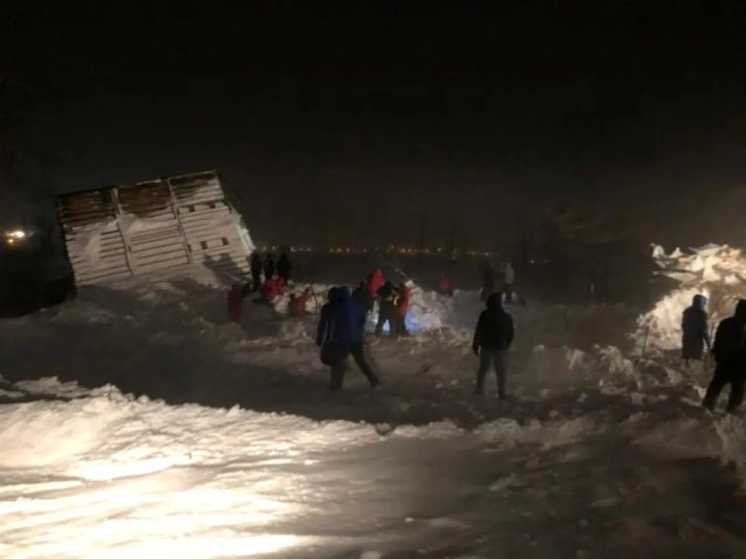 Rescuers and volunteers take part in a search operation after an avalanche hit a ski resort in the Siberian city of Norilsk, Russia January 9, 2021. Russian Emergencies Ministry/Handout via REUTERS