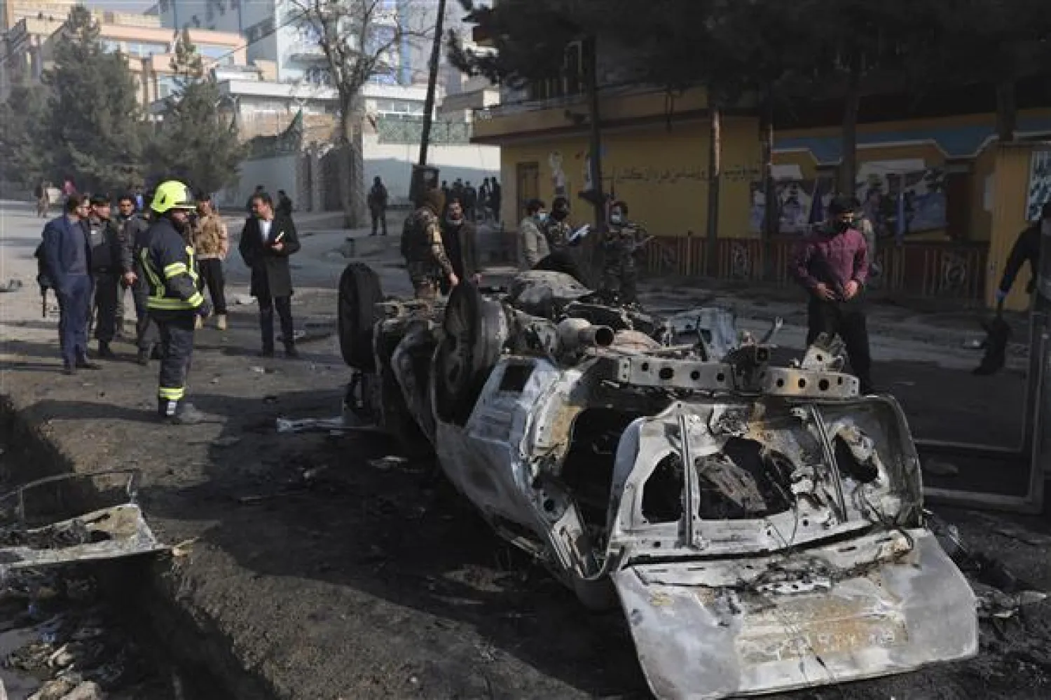 Afghan security officers inspect the site of a bombing attack in Kabul, Afghanistan, Sunday, Jan. 10, 2021. (AP Photo/Rahmat Gul)