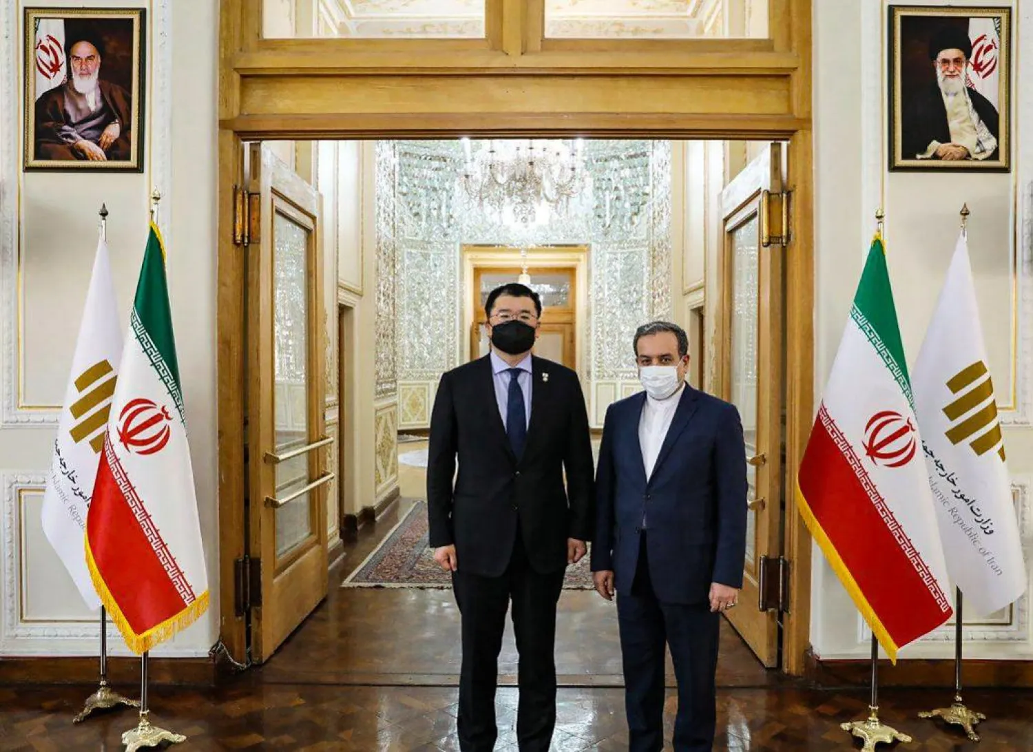Iran's Deputy Foreign Minister Abbas Araghchi, right, and his South Korean counterpart Choi Jong Kun, pose for a photo prior to a meeting in Tehran, Iran, Jan. 10, 2021. (Iran Foreign Ministry via AP)