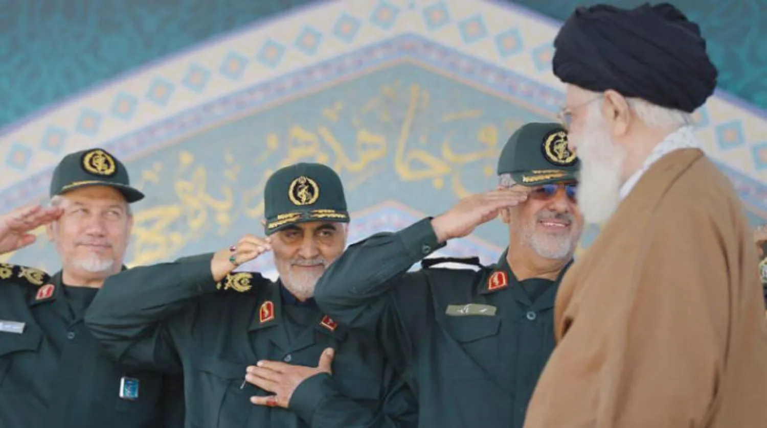 In this file photo, Iran's Khamenei is seen greeting Soleimani (C) and Safavi (R).