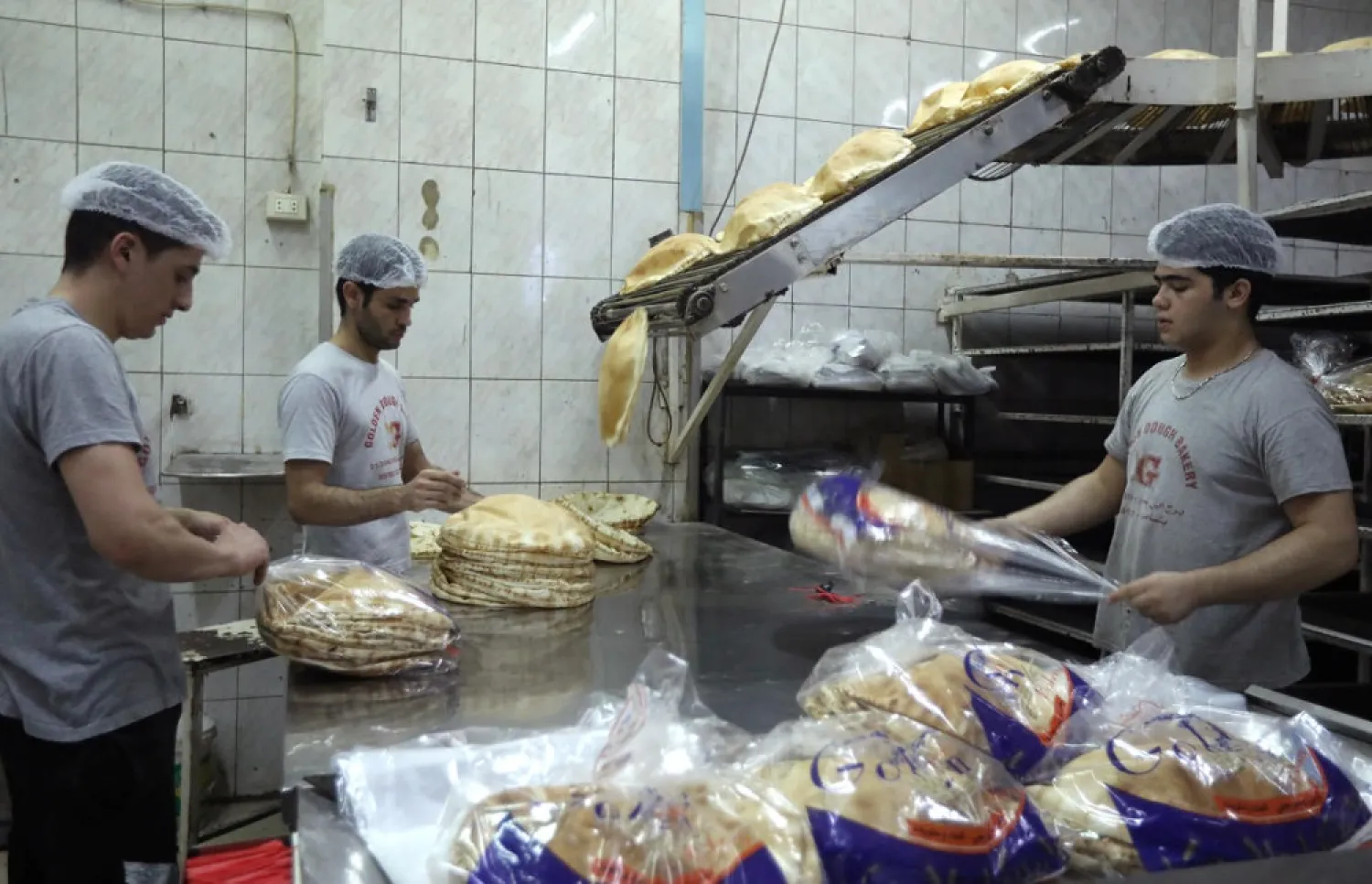 Workers pack bread at a bakery in Beirut, Lebanon June 30, 2020. (Reuters)