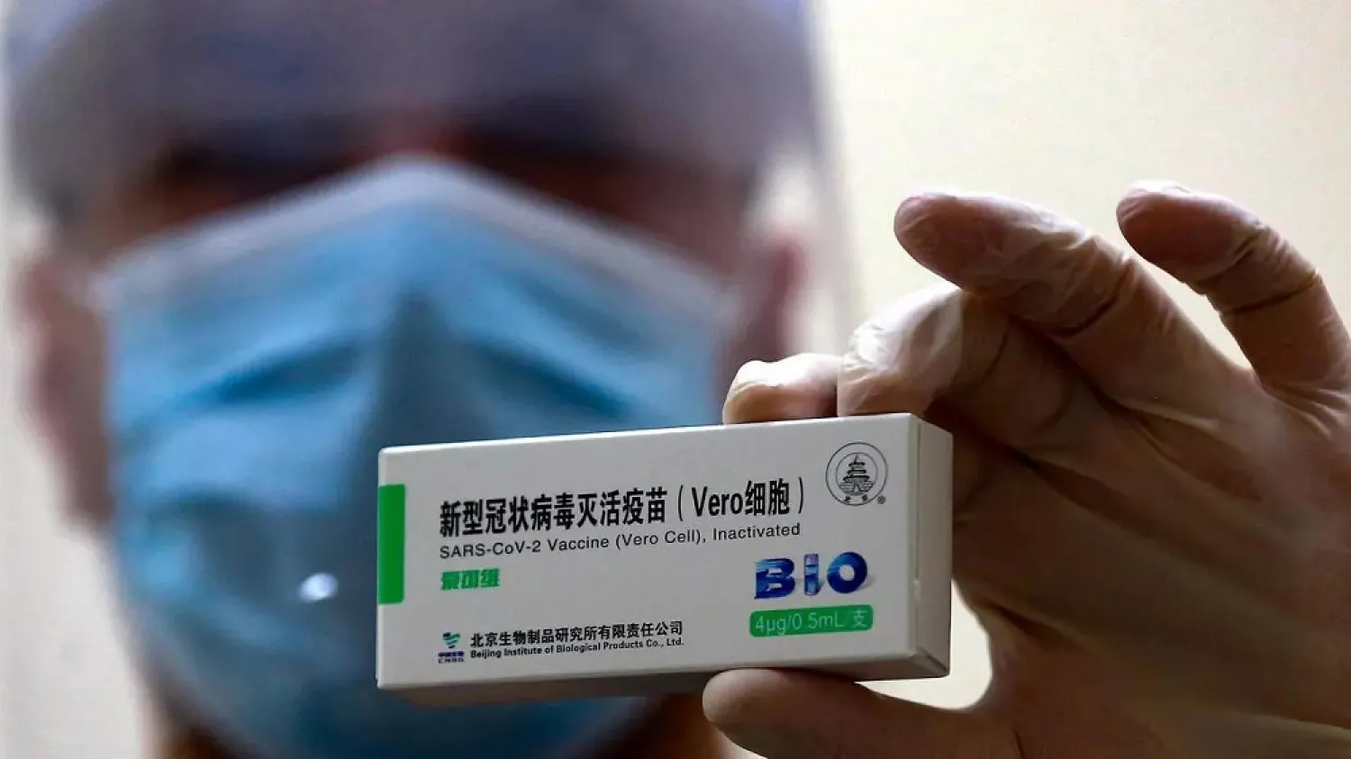 A Jordanian healthcare worker shows a package of China's Sinopharm vaccine against Covid-19 in Amman. (AFP)