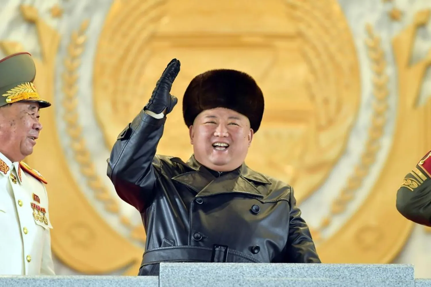 A grinning Kim Jong Un oversaw the parade, wearing a black leather coat and fur hat as he watched infantry troops | AFP
