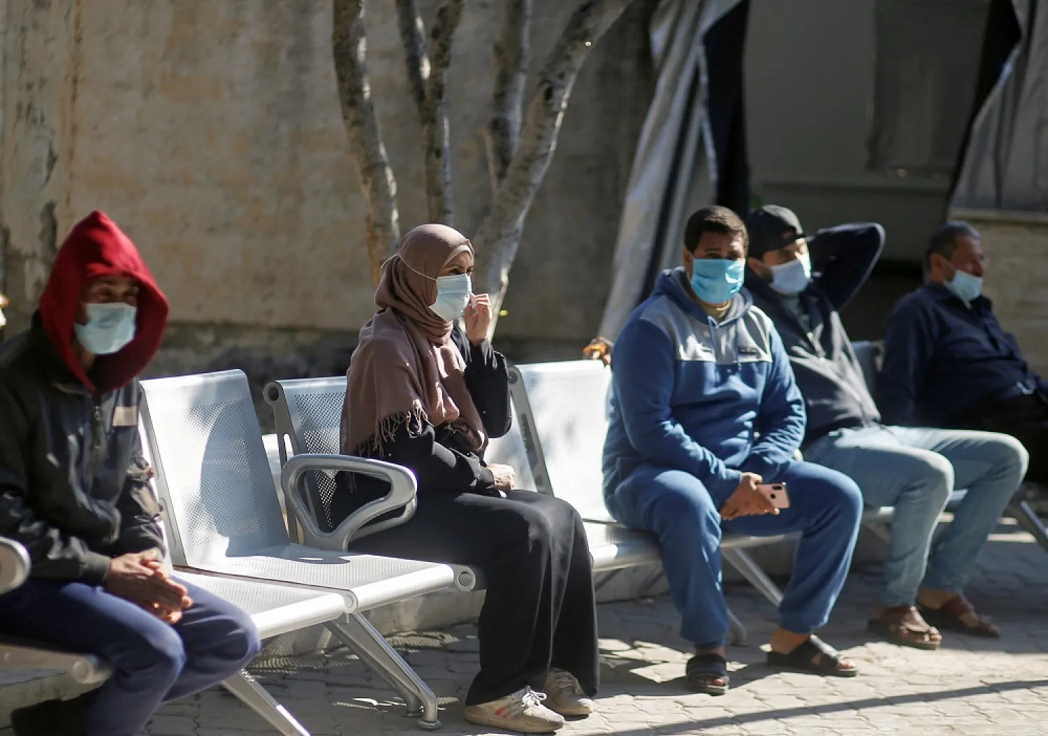 Palestinians wearing protective face masks sit at Shifa hospital, Gaza City, Nov. 22, 2020. (Reuters)