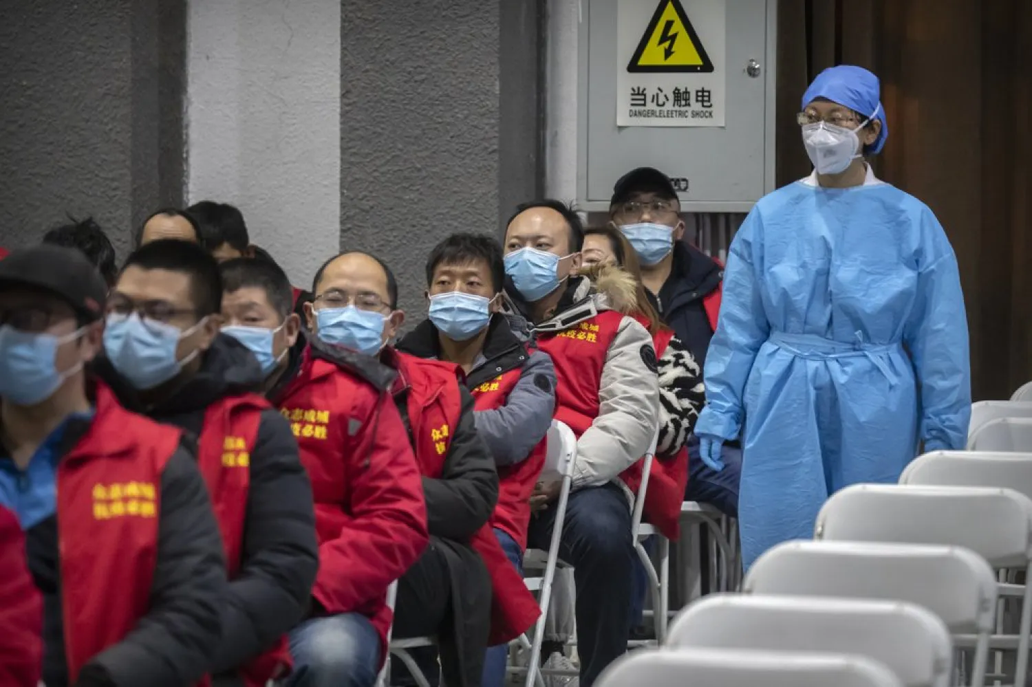 A medical worker wearing protective equipment monitors patients after they received the coronavirus vaccine at a vaccination facility in Beijing, Friday, Jan. 15, 2021. (AP)