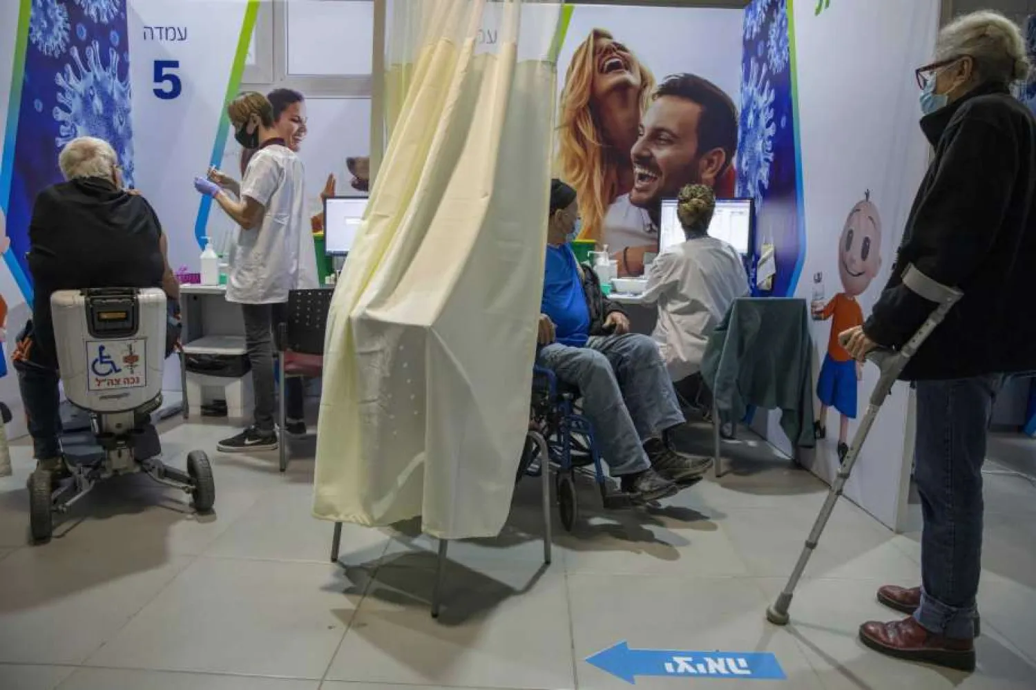 Israelis receive the second Pfizer-BioNTech COVID-19 vaccine, in Netanya, Israel, Tuesday, Jan. 12, 2021. (AP Photo/Ariel Schalit)