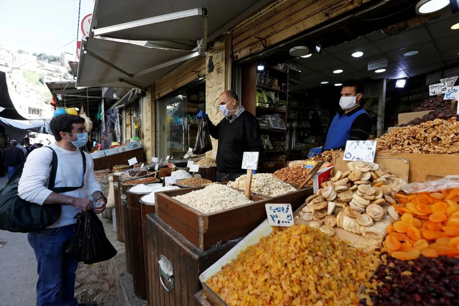 A man wears a face mask amid concerns over the coronavirus disease (COVID-19) as he buys food supplies in Amman, Jordan, April 12, 2020. (Reuters)