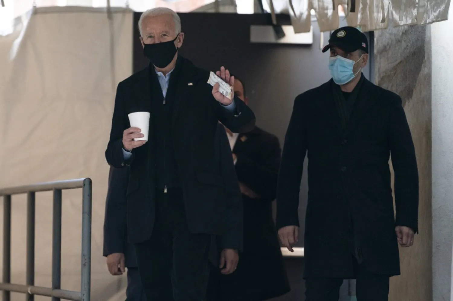 President-elect Joe Biden waves to reporters as walks out of The Queen theater Monday, Jan. 18, 2021, in Wilmington, Del. (AP Photo/Evan Vucci)

