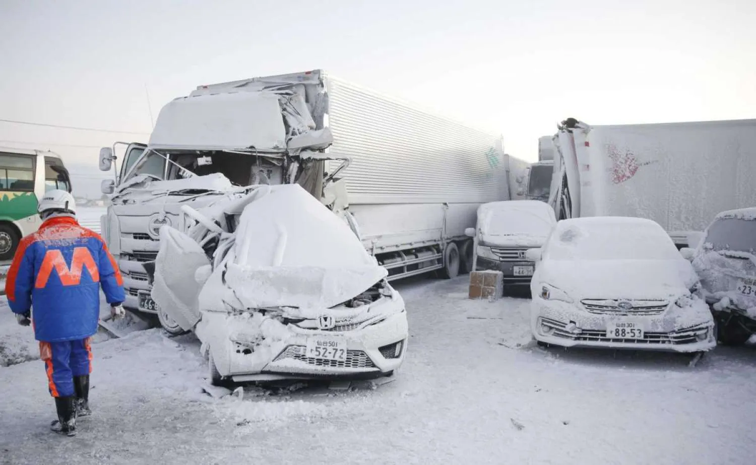 Damaged cars are covered with snow after a multiple accident on the Tohoku Expressway in Osaki city, Miyagi prefecture, northern Japan, Tuesday, Jan. 19. 2021. (Yusuke Ogata/Kyodo News via AP)