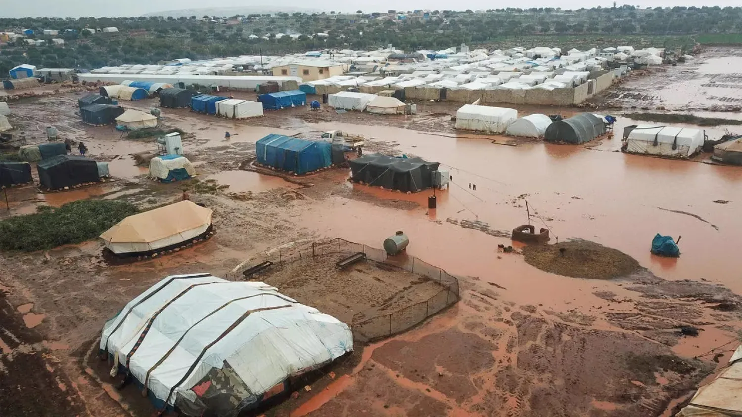 A drone photo taken on January 17, 2021, shows the Umm Jurn displacement camp near the village of Kafr Uruq, in Syria's rebel-held Idlib province, after heavy rain. (AFP)