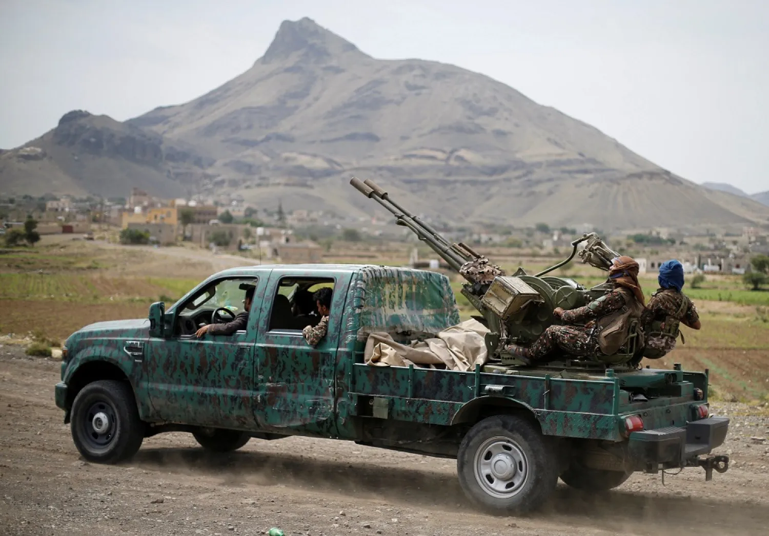 Houthi fighters man a machine gun mounted on a military truck as they parade during a gathering of Houthi loyalists on the outskirts of Sanaa, Yemen July 8, 2020. (Reuters)