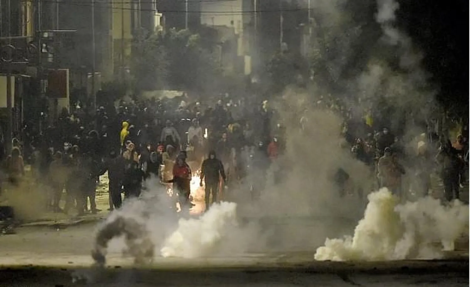 Protesters clash with security forces in the Ettadhamen suburb of Tunis on Monday night- AFP
