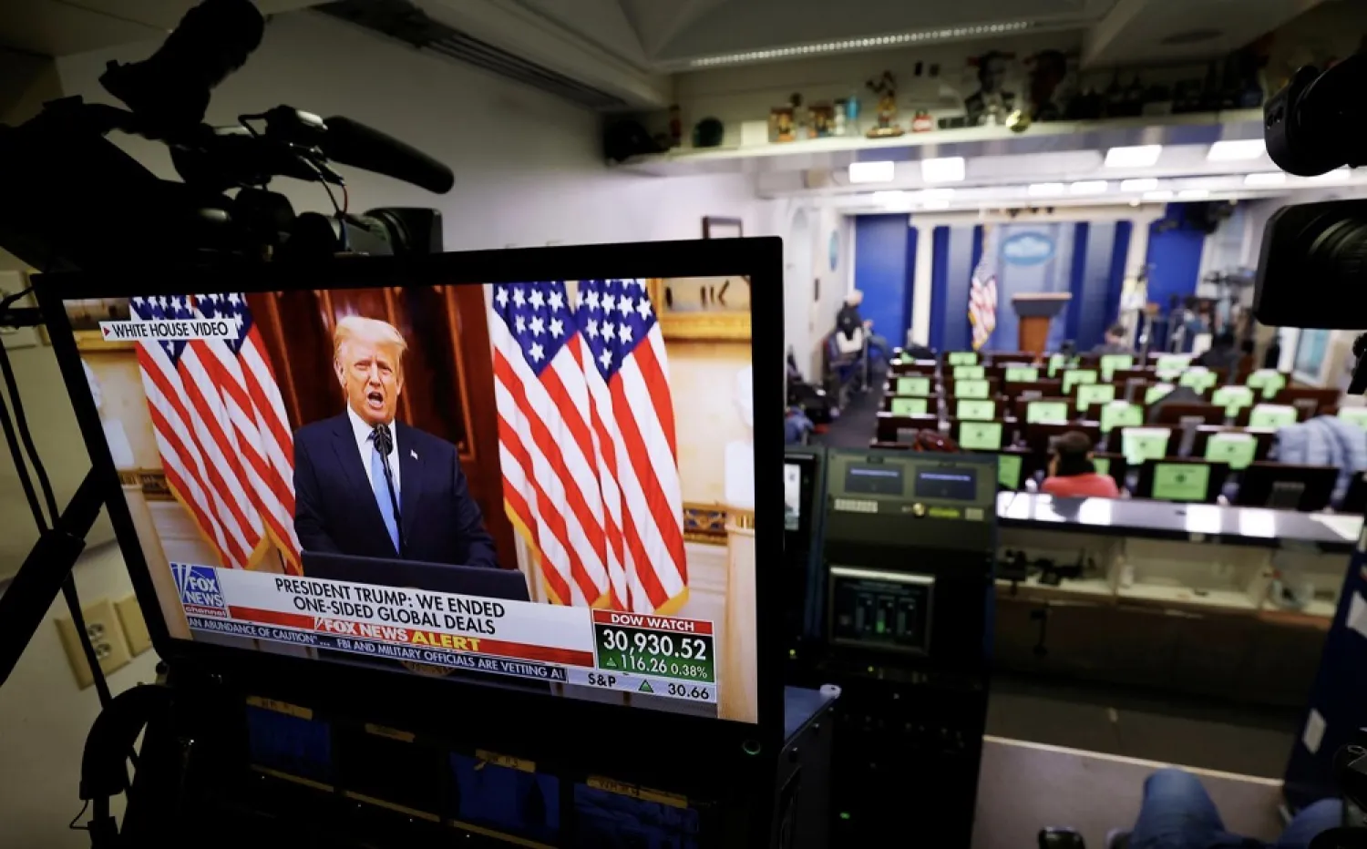 US President Donald Trump makes remarks on a television monitor from the White House Briefing Room during his last day in office, in Washington, DC, US, January 19, 2021. (Reuters)