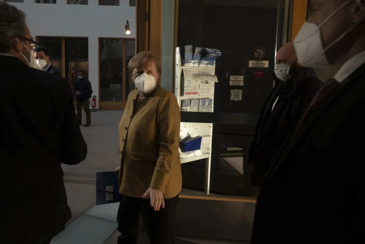 German Chancellor Angela Merkel, center, arrives for a news conference about the current situation of the coronavirus pandemic and the nation's measures to avoid the further spread of the COVID-19 disease, in Berlin, German, Thursday, Jan. 21, 2021. (AP Photo/Markus Schreiber)