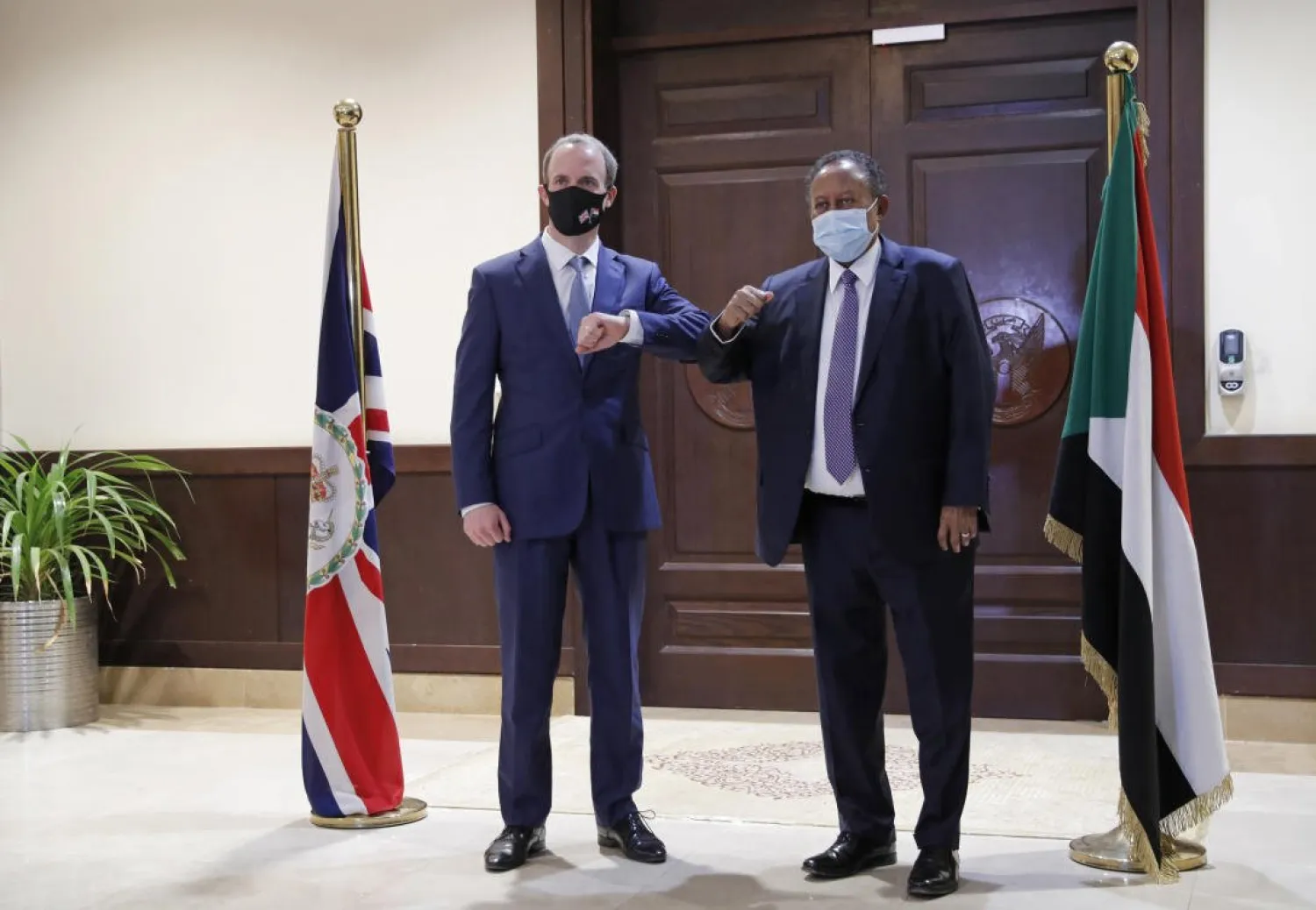 Sudanese Prime Minister Abdalla Hamdok, right, bumps elbows with British Foreign Secretary Dominic Raab in the Cabinet Building, in Khartoum, Sudan, Thursday, Jan. 21, 2021. AP Photo