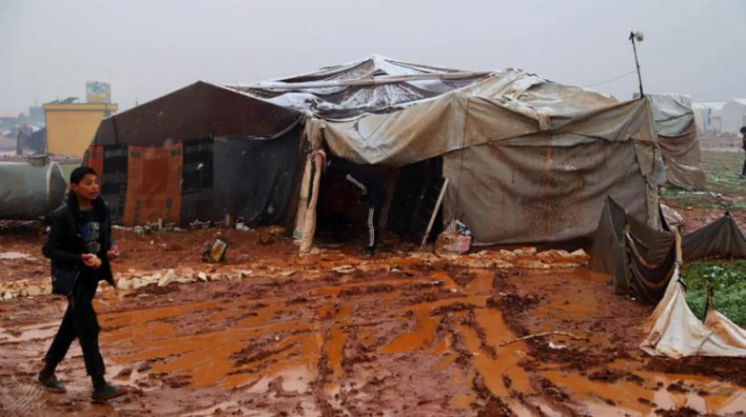A Syrian child walks on mud as snow fall on a camp for internally displaced Syrians near the town of Ad Dana. The refugee camps in the north of Idlib governorate are under threat of extreme winter weather with heavy rain and snowfall. Photo: Juma Muhammad/IMAGESLIVE via ZUMA Wire/dpa