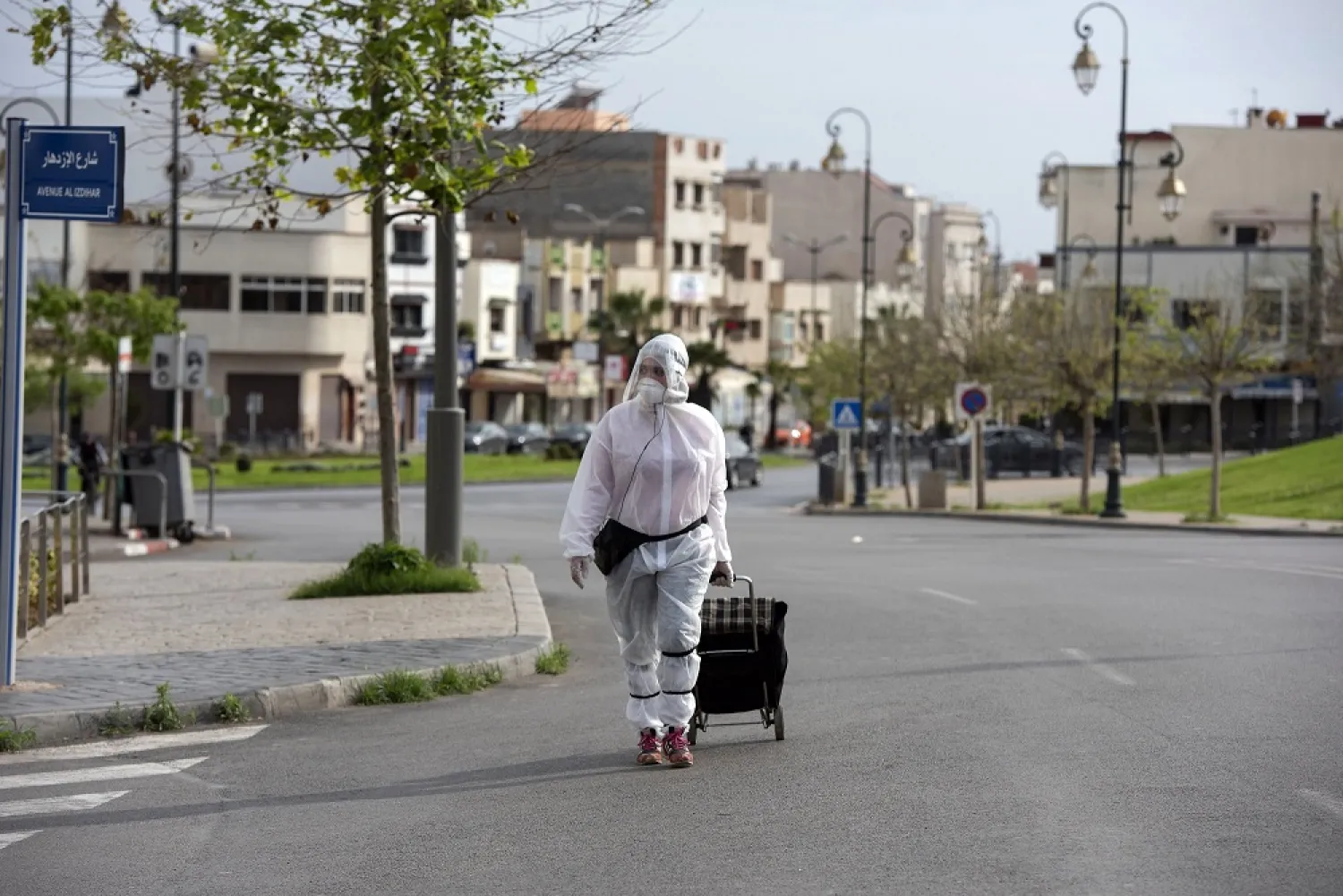 A Moroccan woman wearing protective clothing, volunteers to buy the necessary supplies from the shops and distribute them to the needy in Rabat, Morocco, April 18, 2020. (EPA)