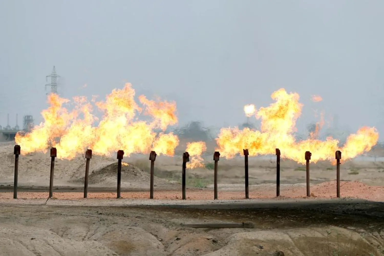 FILE PHOTO: Flames are seen at a station in al-Zubair oilfield, near Basra, Iraq April 21, 2020. REUTERS/Essam Al-Sudan/File Photo
