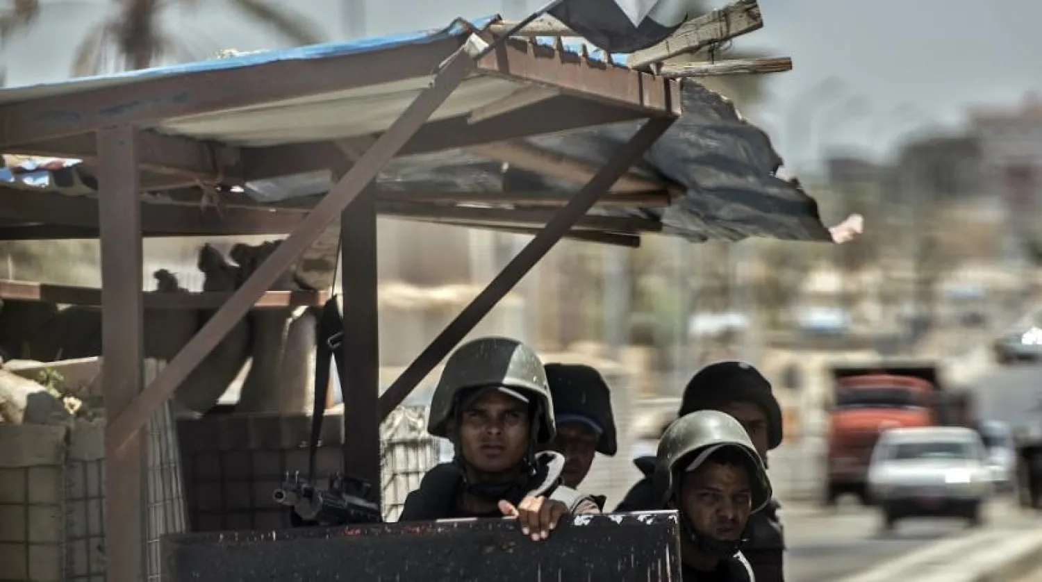 Egyptian policemen stand guarding at a checkpoint on a road leading to the North Sinai provincial capital of El-Arish. (AFP)
