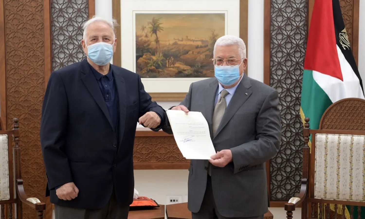 Palestinian President Mahmoud Abbas hands the election decree to Chairman of the Palestinian Central Election Committee Hana Naser in Ramallah in the West Bank January 15, 2021. (Reuters)