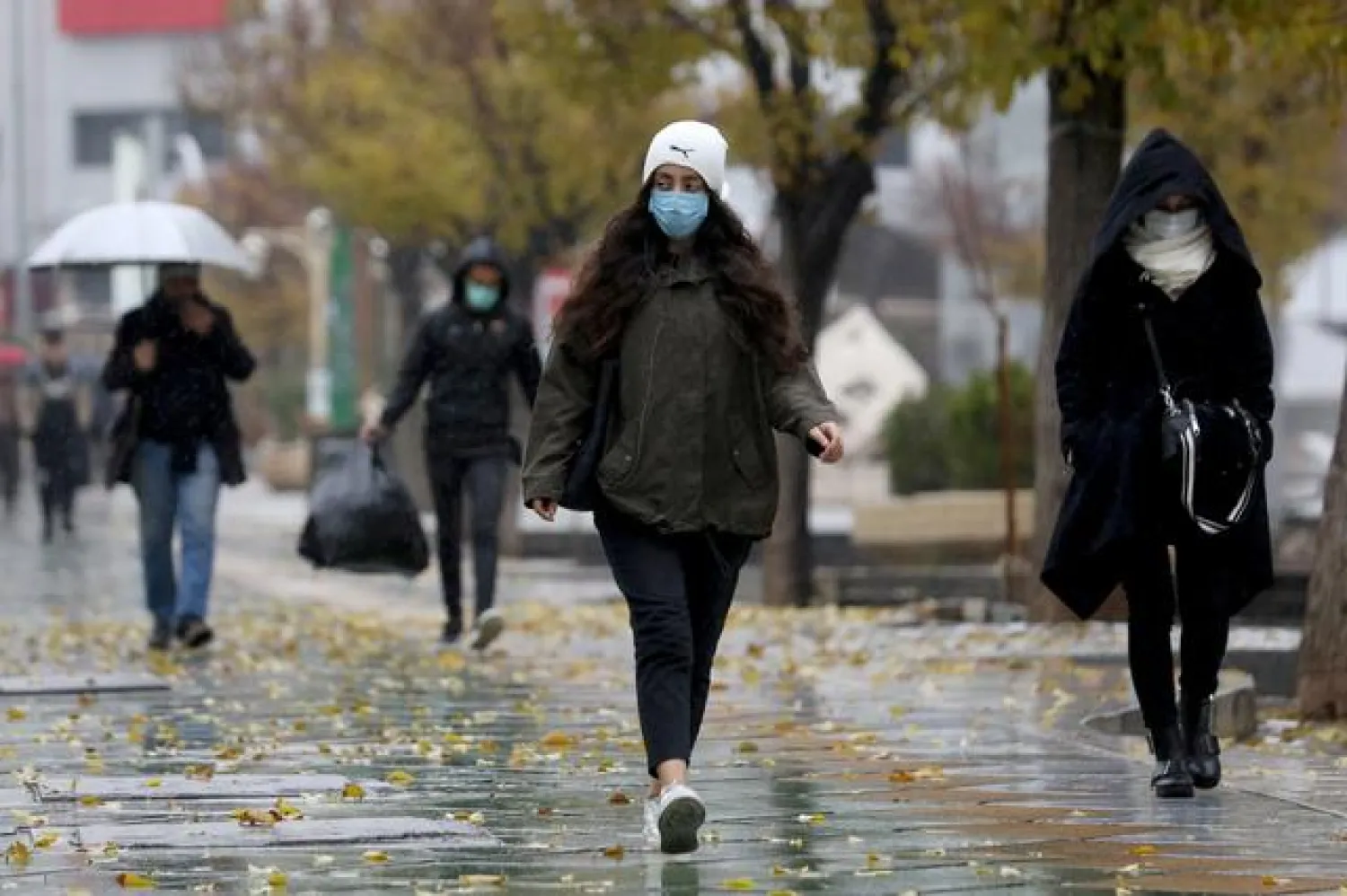 FILE PHOTO: People walk on a street after Tehran reopened following a two-week shutdown, amid the coronavirus disease (COVID-19), Iran December 6, 2020. Majid Asgaripour/WANA (West Asia News Agency) via REUTERS