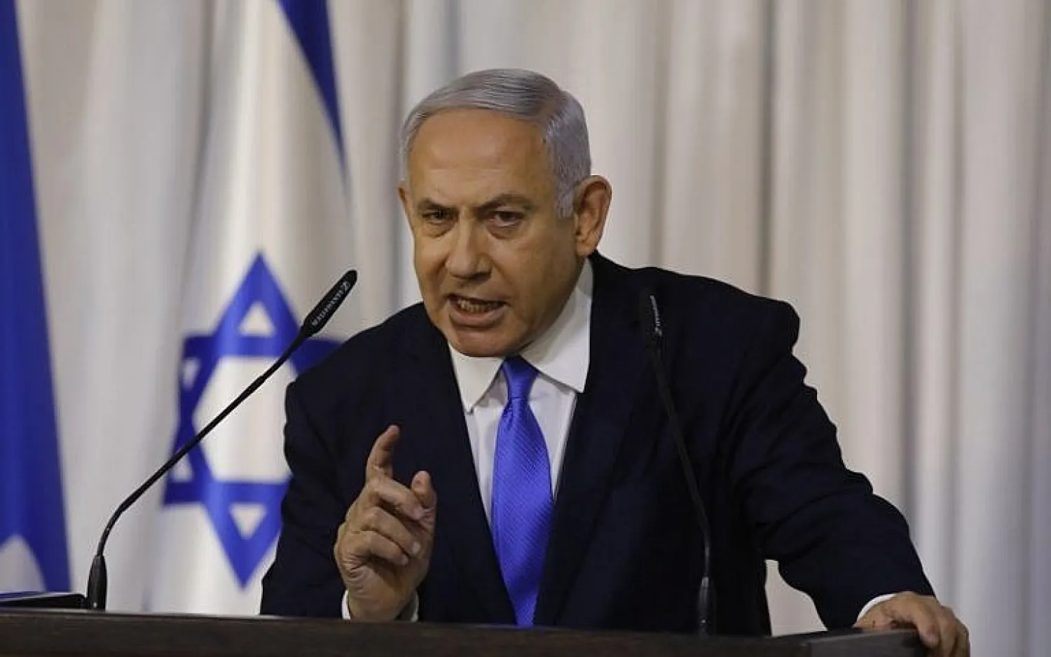 Prime Minister Benjamin Netanyahu gives a televised statement after a meeting of his ruling Likud party in Ramat Gan on February 21, 2019. (Menahem Kahana/AFP)