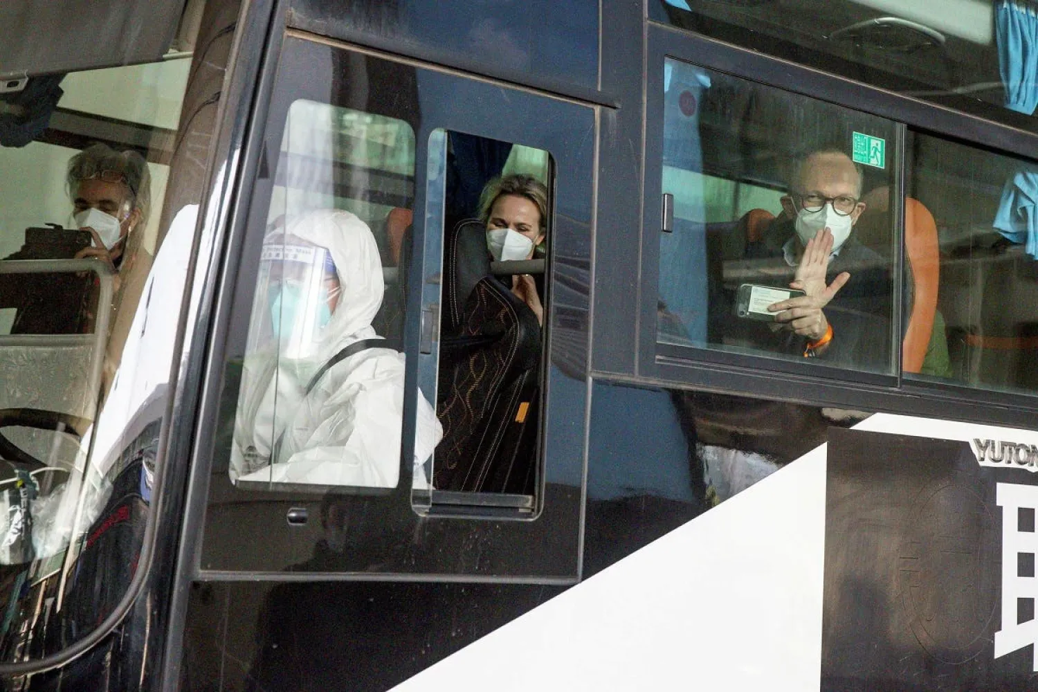 WHO team sits on a bus while leaving Wuhan Tianhe International Airport in Wuhan, Hubei province, China, January 14, 2021. Reuters