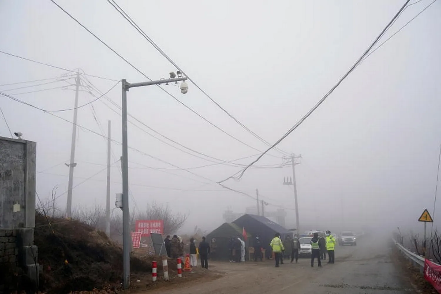 Security guards keep watch at an entrance to the Hushan gold mine after the January 10 explosion, in Qixia, Shandong province, China. (Reuters)