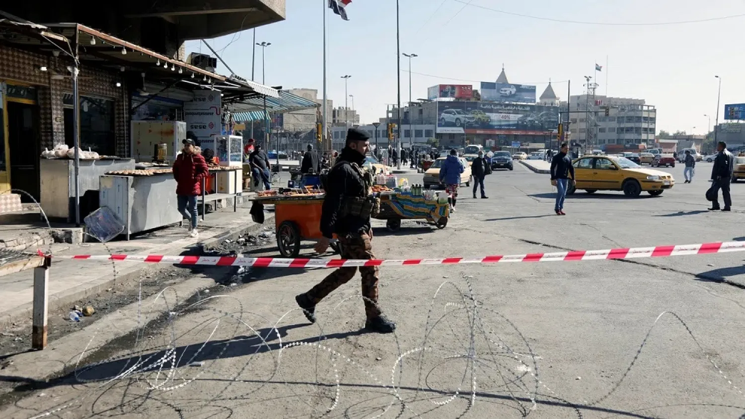 An Iraqi security force member walks near the damage site in the aftermath of a twin suicide bombing attack in a central market, in Baghdad, Iraq January 22, 2021. (Reuters)