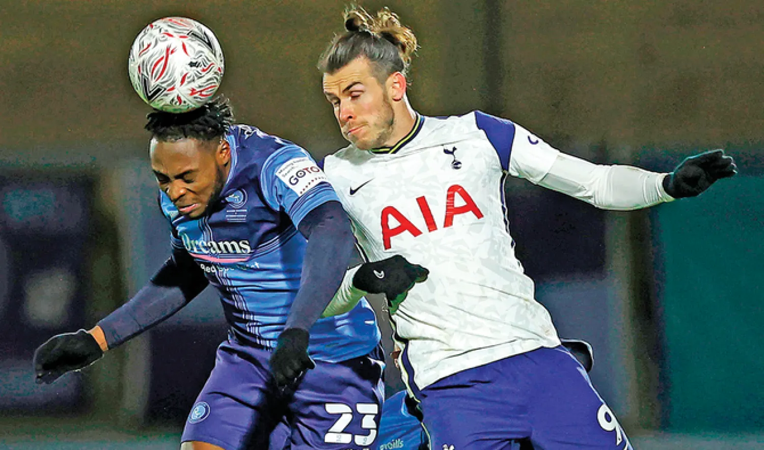 Wycombe Wanderers’ Nigerian midfielder Fred Onyedinma, left, vies with Tottenham Hotspur’s Welsh striker Gareth Bale, right, in Monday’s match in London. (AFP)
