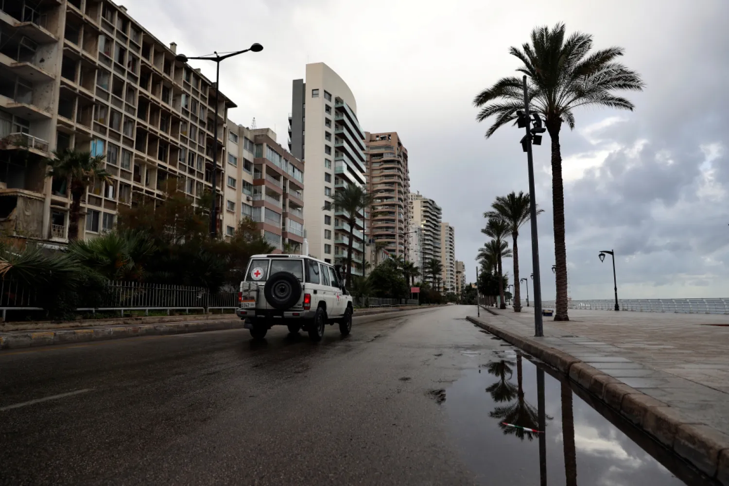 A Red Cross vehicle drives along the empty waterfront promenade as the country starts a new lockdown, in Beirut, Lebanon, Thursday, Jan. 14, 2021. (AP)