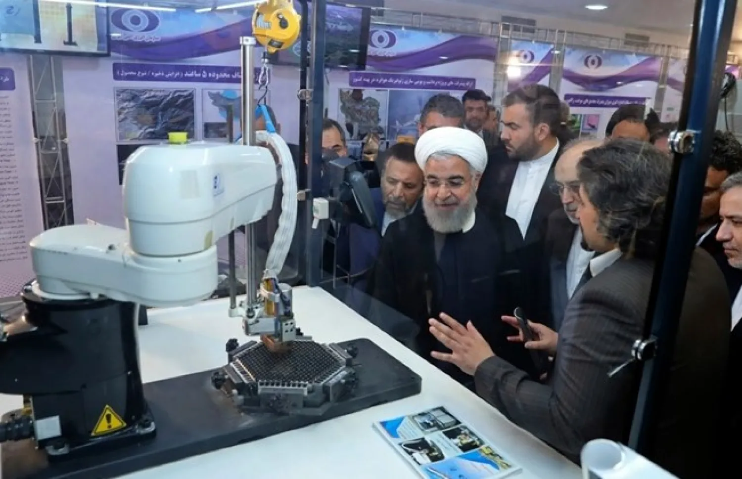 In this April 9, 2018, file photo, released by an official website of the office of the Iranian Presidency, President Hassan Rouhani listens to explanations on new nuclear achievements at a ceremony to mark "National Nuclear Day," in Tehran. (Iranian Presidency Office via AP)

