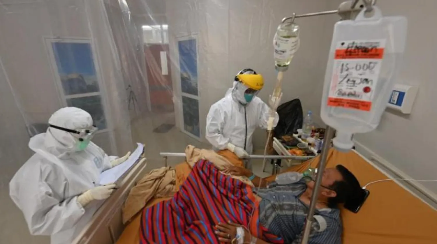 Endonezya’daki bir hastanede koronavirüs hastası ile ilgilenen doktorlar (AFP)
