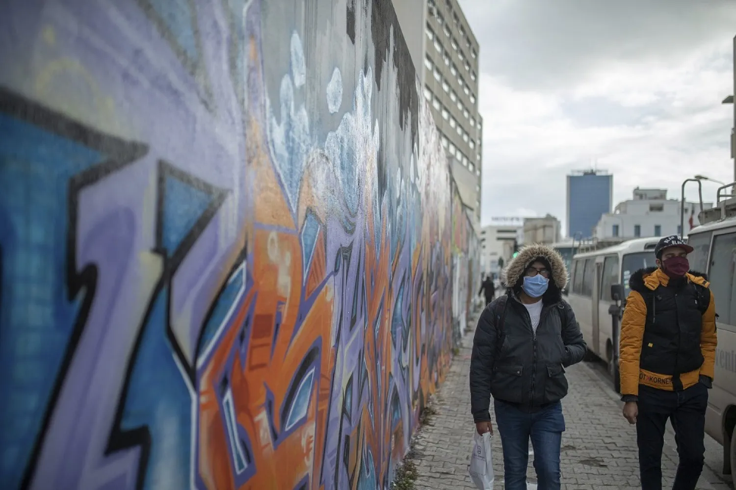 People wearing face masks are seen in Tunis on January 12, 2021. (AP)