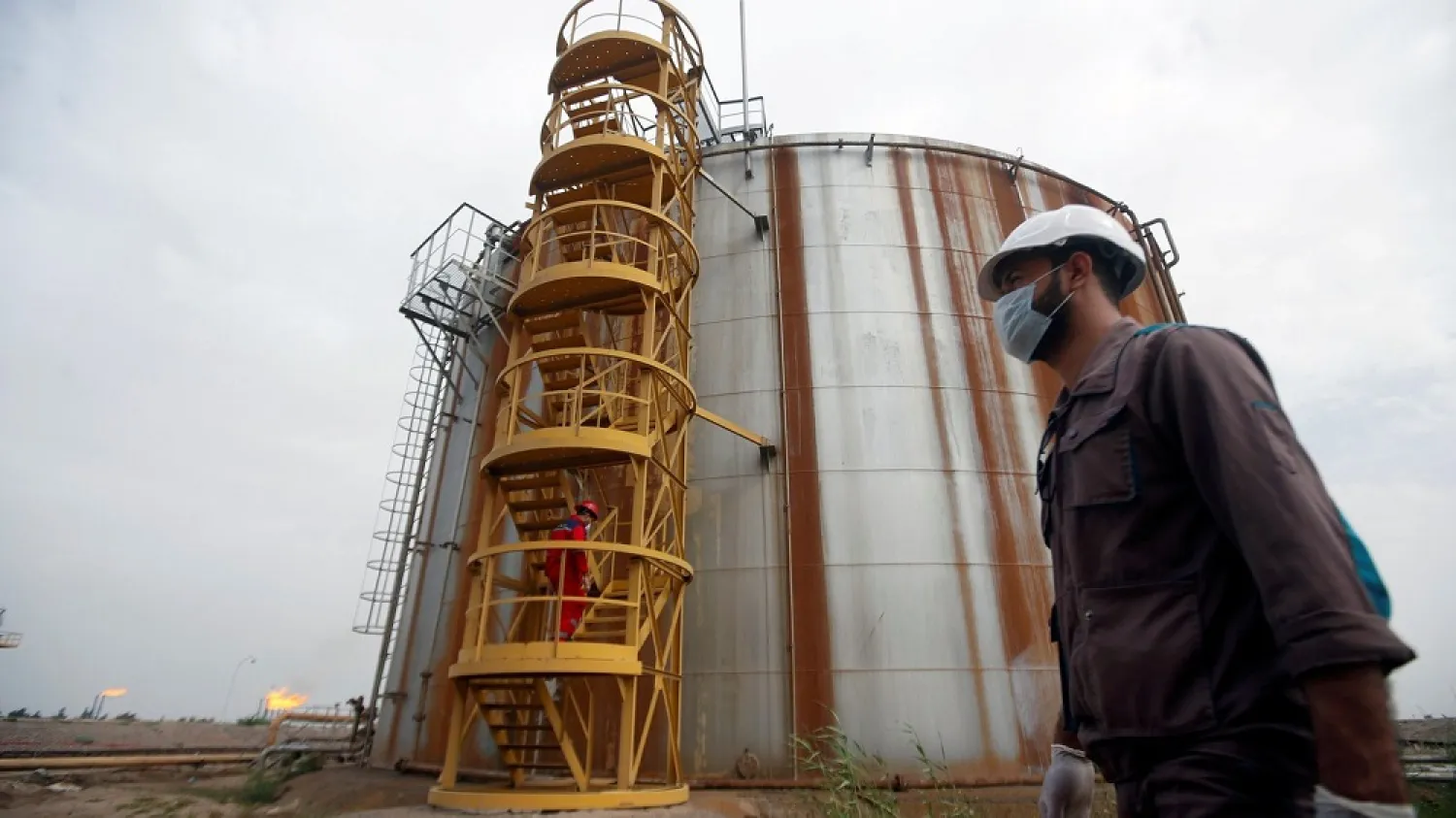 A worker wears a protective mask, following an outbreak of coronavirus, at Nahr Bin Umar oil field, north of Basra, Iraq March 15, 2020. (Reuters)