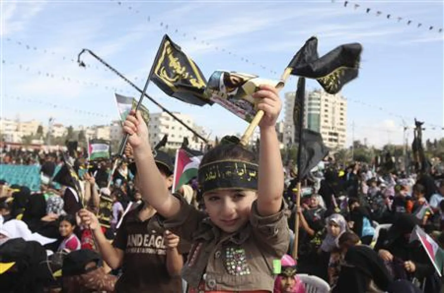 Caption: A Palestinian girl waves Islamic Jihad flags during a rally in Gaza City October 29, 2010. REUTERS/Mohammed Salem