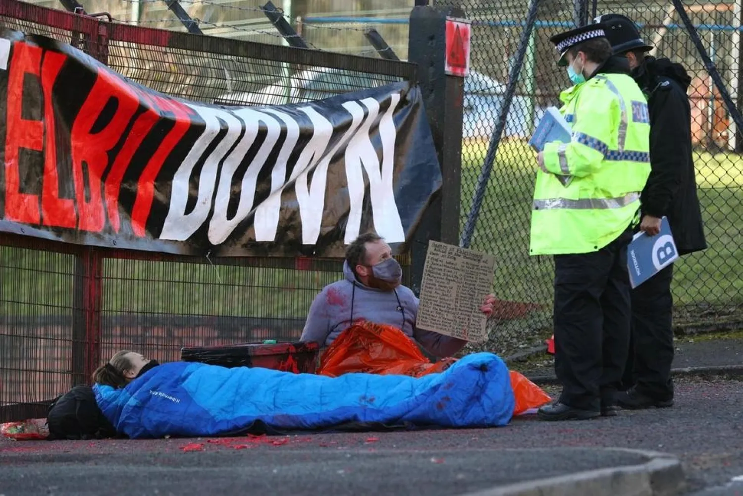Police talk to protesters blocking the entrance to Israeli-owned Elbit Ferranti arms company in Oldham, Greater Manchester, England, Monday, Feb. 1, 2021. (AP)