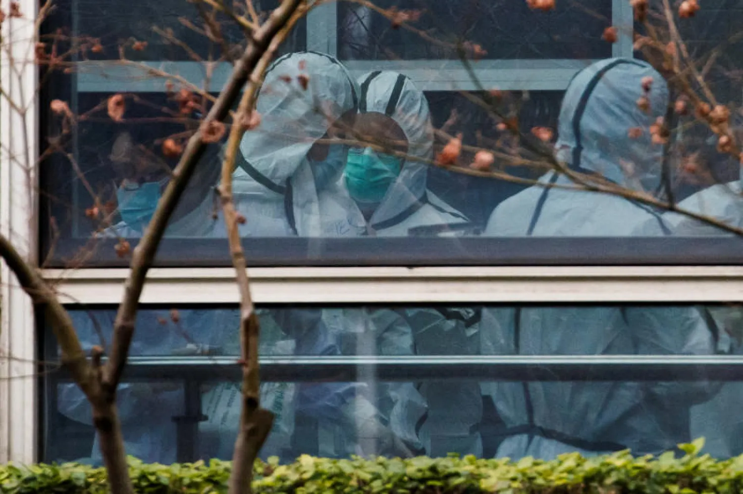 اعضاء من فريق منظمة الصحة العالمية يرتدون بدلات حماية شخصية خلال زيارة لمركز هوبي للوقاية من الأمراض الوبائية الحيوانية ومكافحتها في ووهان(رويترز)